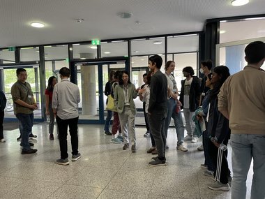 Students are shown discussing in the foyer