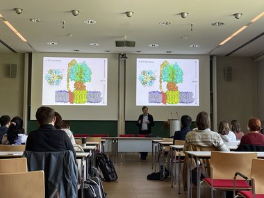 Students sitting in a seminar room and listening to a presentation