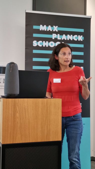 Guest speaker Zeynep Ökten underscores her talk with gestures and facial expressions, eyebrows raised, with much enthusiasm for the subject.