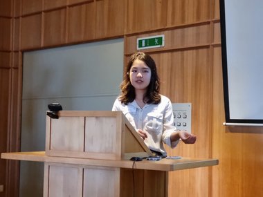 Ailene Chan from the Croucher Foundation gives a lecture and emphasizes her words with gestures.