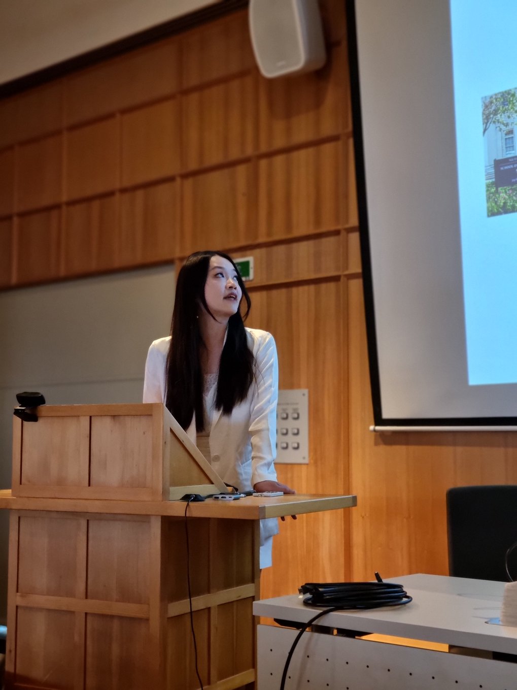 Chloe Huang from the Croucher Foundation presents her research. She is taking a look at her slides.