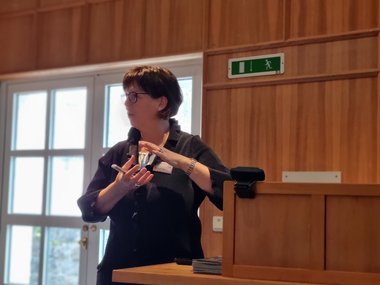MtL Fellow Karin Jacobs gestures with both hands while explaining a concept during her lecture.