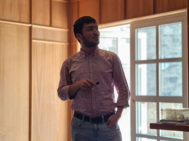 MtL student Sunnatullo Fazliev looks up at his slides during his presentation.