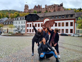 Matter to Life Undergraduate Research Opportunities Students posing with umbrellas against the backdrop of Heidelberg Castle
