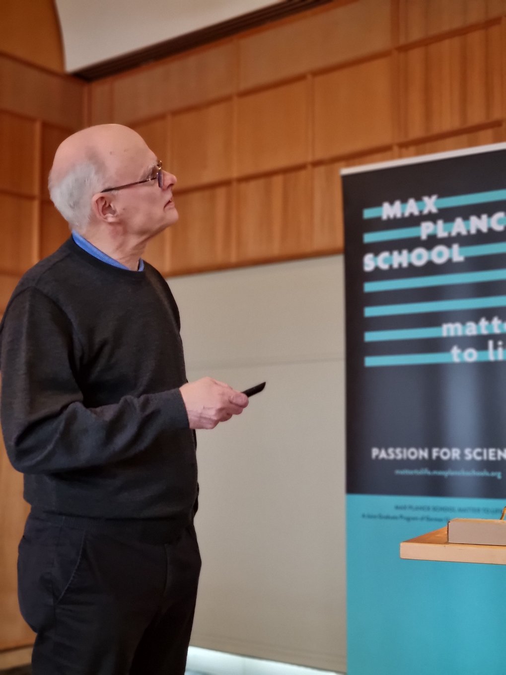 Faculty member Reinhard Lipowsky looks up at his slides during his talk
