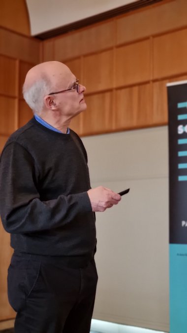 Faculty member Reinhard Lipowsky looks up at his slides during his talk
