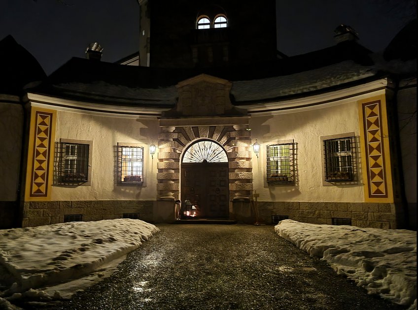 Ringberg Castle goes beyond being a mere venue for conferences - it offers a charming backdrop for our scientific discussions Path to the illuminated entrance of Ringberg Castle in the evening, there is snow next to the path