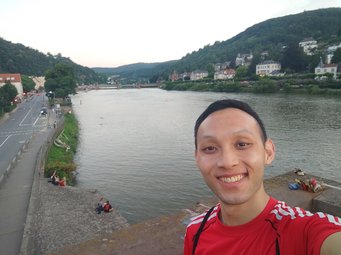 Selfie of Li Jing in front of the river that flows through Heidelberg