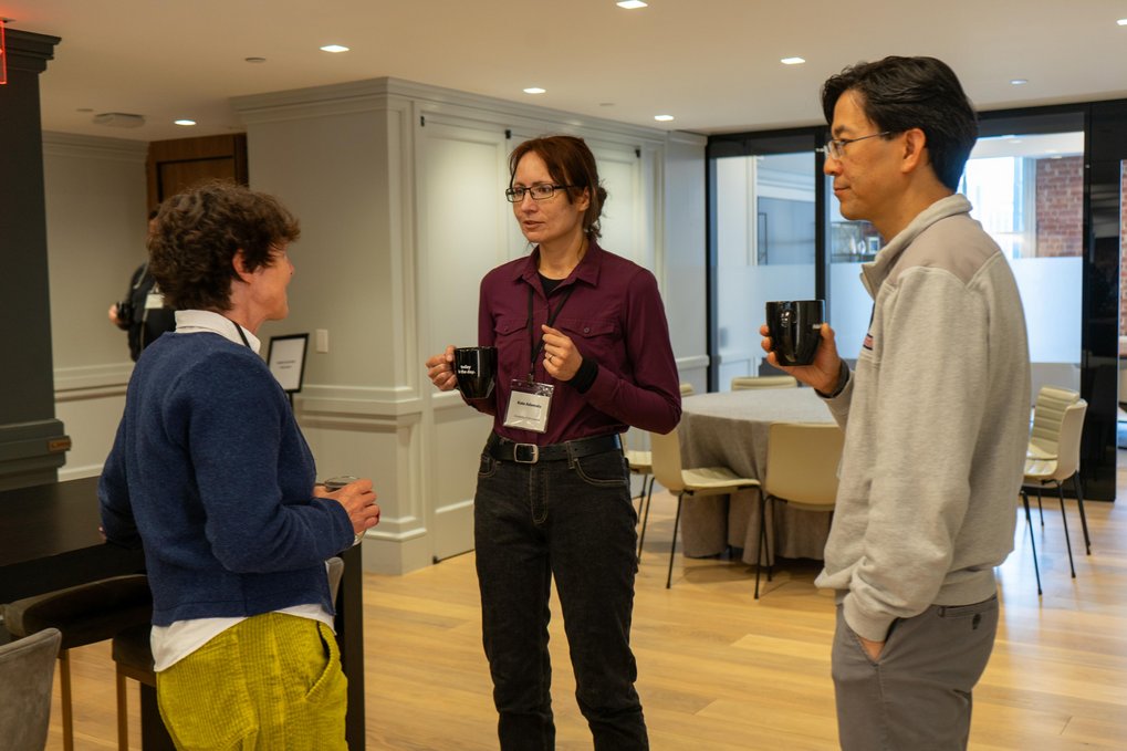 Three individuals engaged in conversation 