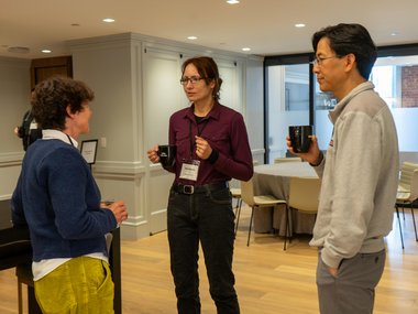 Three individuals engaged in conversation