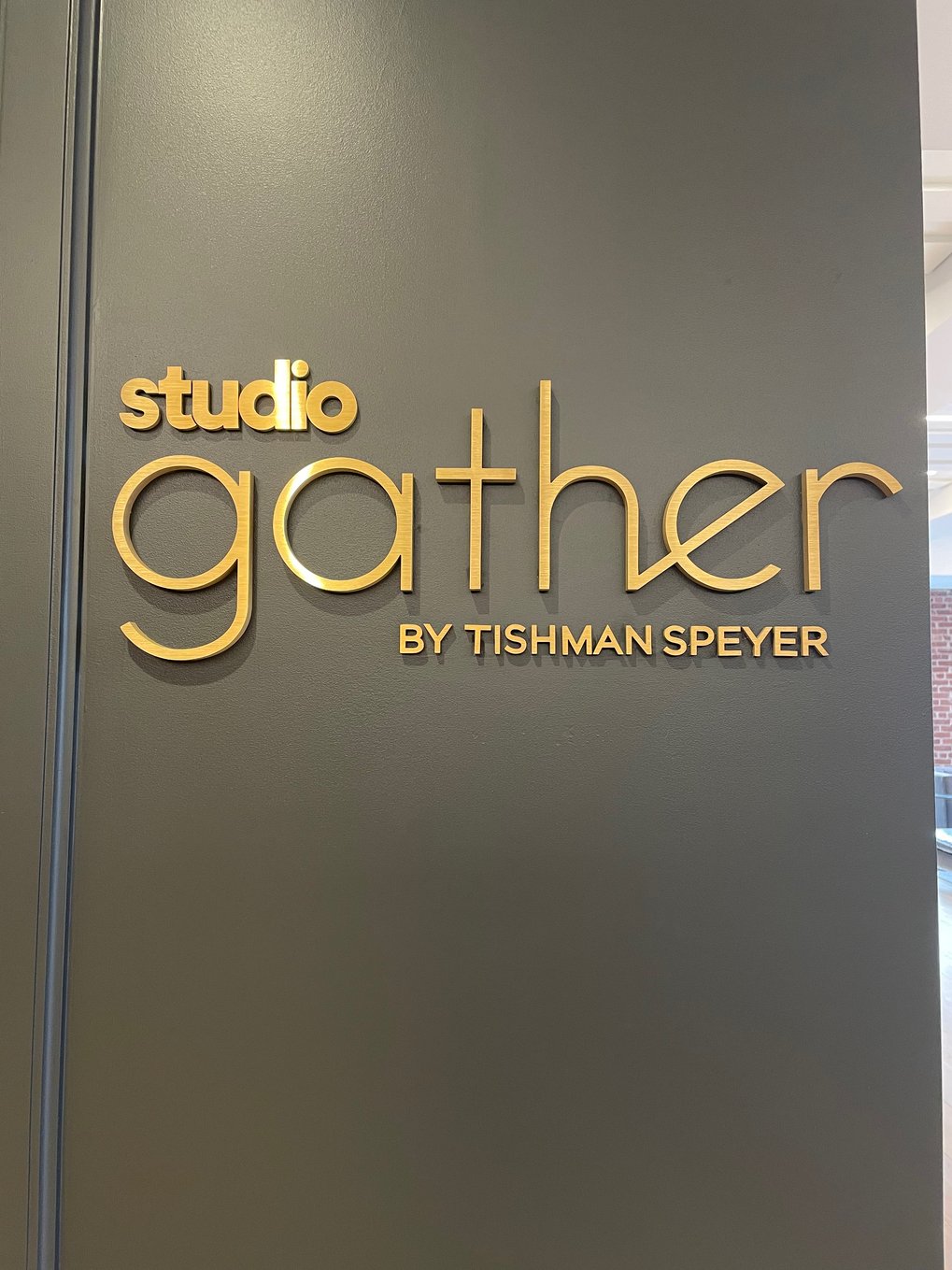 A sign "Studio Gather by Tishman Speyer" located in Rockefeller Plaza