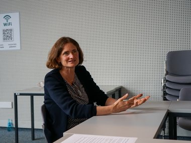 Matter to Life Fellow Tanja Weil sitting at a table, communicating