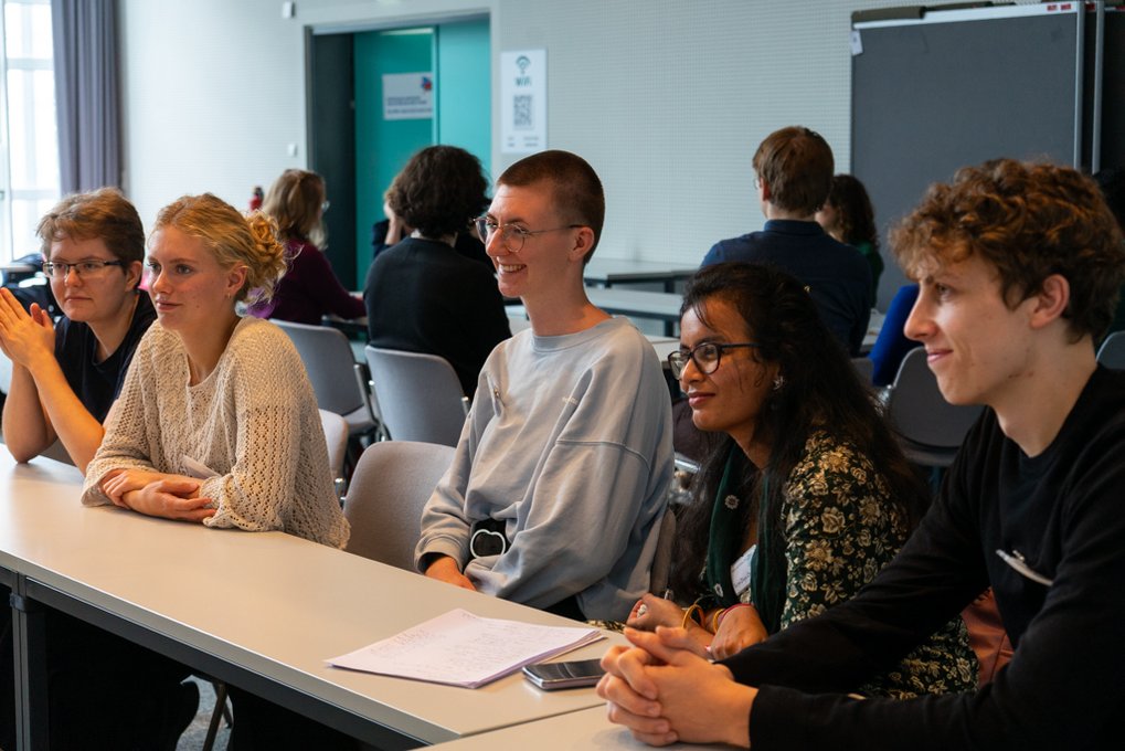 Matter to Life PhD candidates seated in a lecture hall setting, engaging attentively.