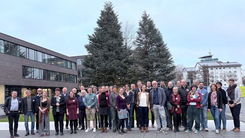 Matter to Life Fellows in Heilbronn, ready for a New Era Group gathered outside a building, with trees in the background, appearing casual and friendly.