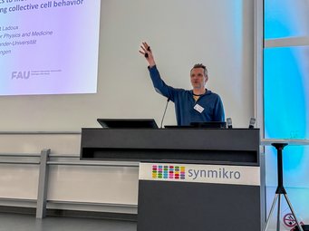 Our Fellow Benoît Ladoux delivered an exciting keynote lecture on “From Active Nematics to Mechano-Hydraulics: Physical Forces Shaping Collective Cell Behavior” Matter to Life Fellow Benoît Ladoux at a podium gesturing during a presentation, with a slide titled "From physics to mechano-hydraulics: understanding collective cell behavior" visible on the left.